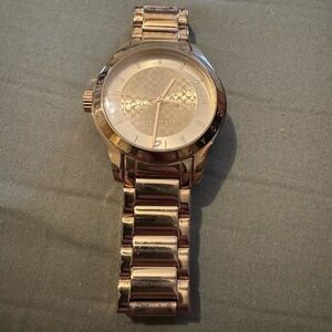 Women’s gold Coach watch
